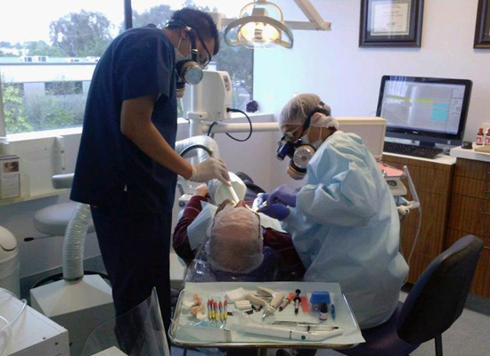 Dr. Zraigat safely removing a mercury amalgam filling